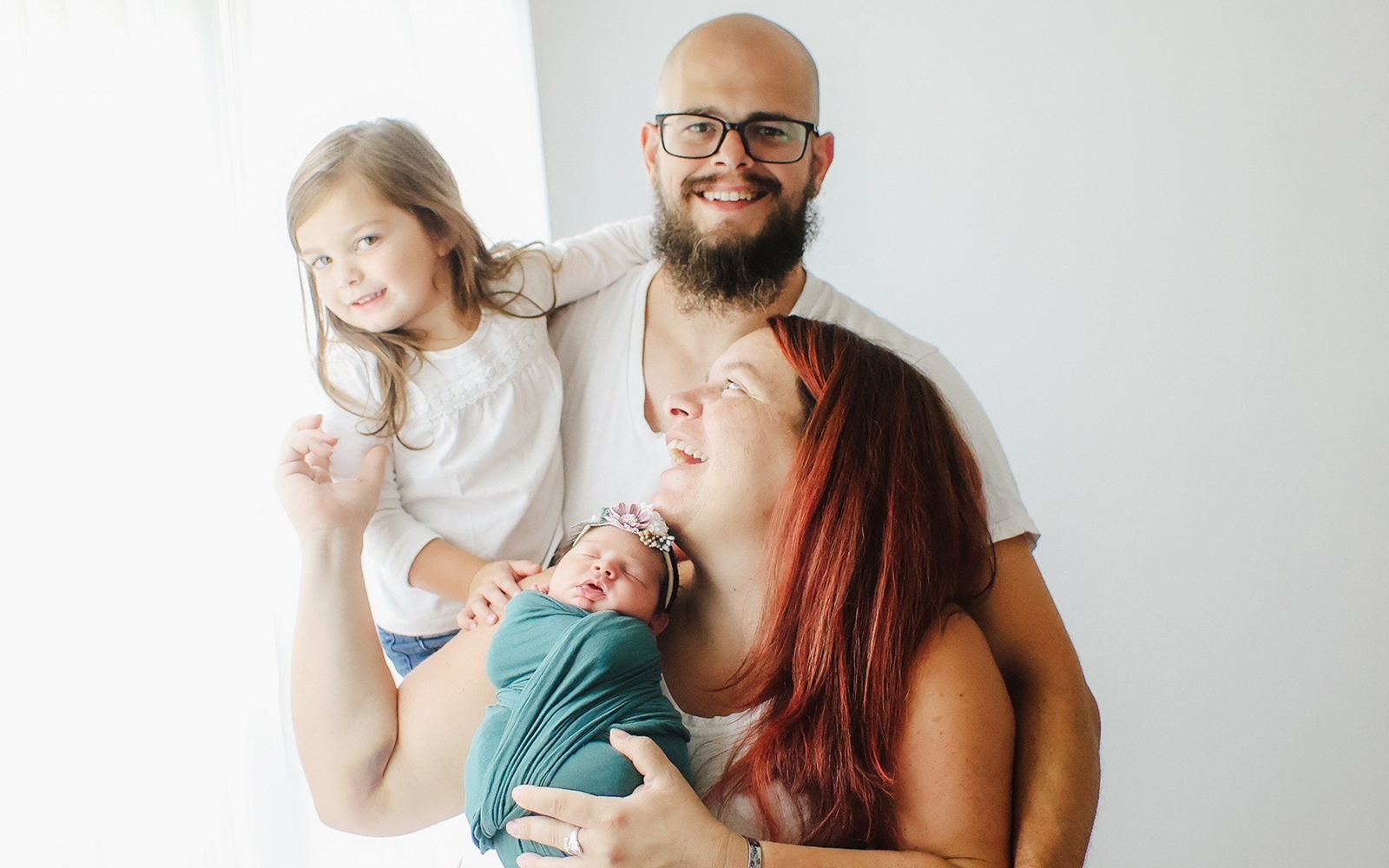 Mom and dad with a toddler and baby
