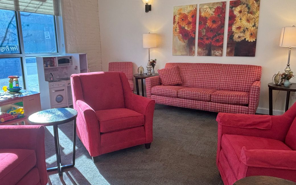 reception waiting room with bright pink furniture