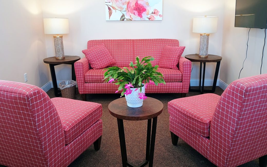 counseling room with pink checkered couch and matching chairs
