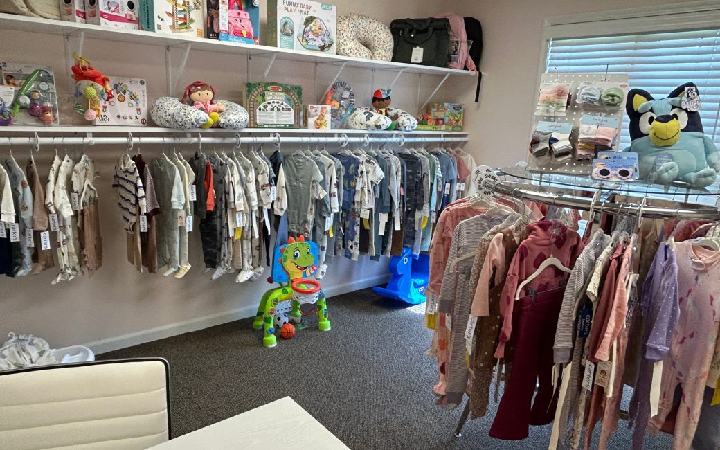 crib club with baby clothes and items